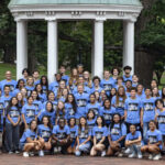 Students in the Summer Bridge program pose for a portrait with Chancellor Kevin M. Guskiewicz on July 25, 2022, at the Old Well on the campus of the University of North Carolina at Chapel Hill.