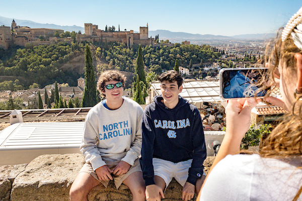 Two students in Carolina shirts pose for a picture in Spain